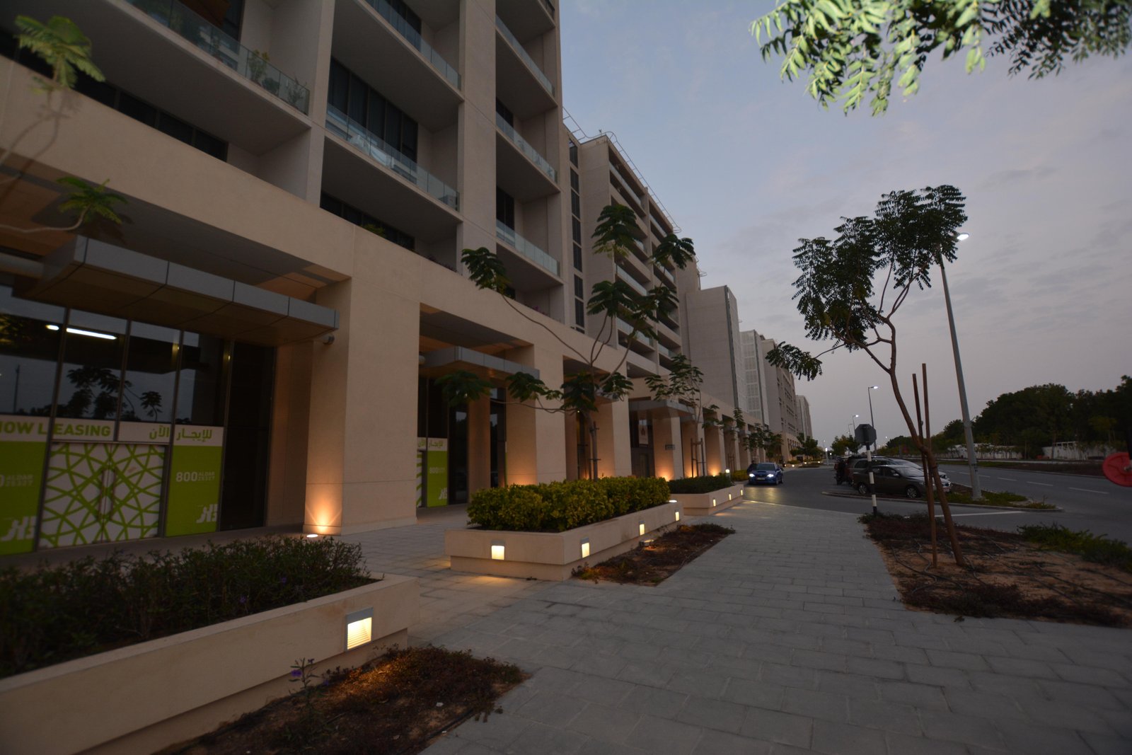 Aerial view of Al Zeina waterfront promenade and landscaped green courtyards in Al Raha Beach Abu Dhabi.